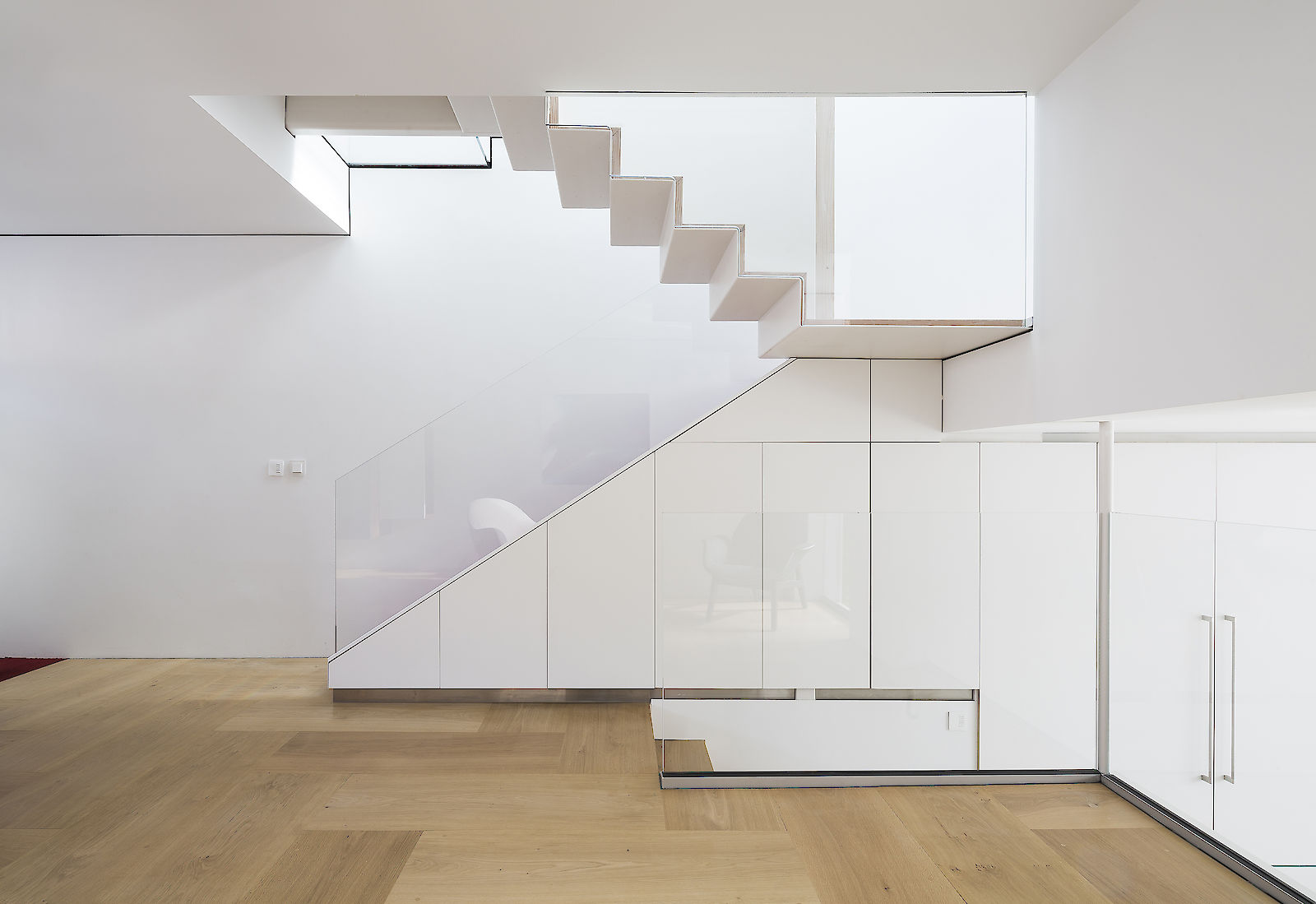 GC House in Fulham by inaki leite design. Elevation of ground floor red stairs, folded steps with cascade skylight two floors on top