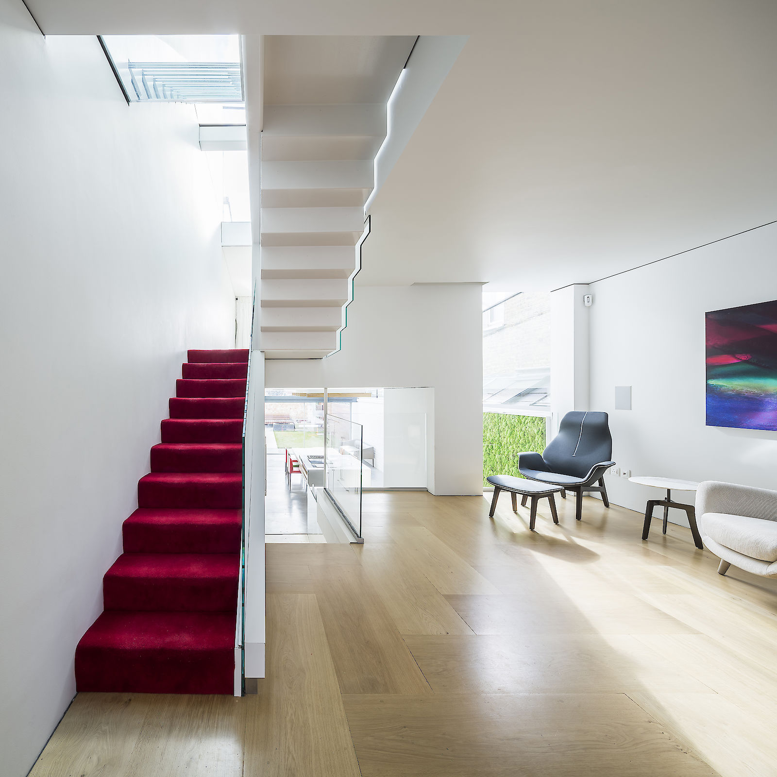 GC House in Fulham by inaki leite design. Ground floor open plan with red stairs, folded steps and cascade skylight