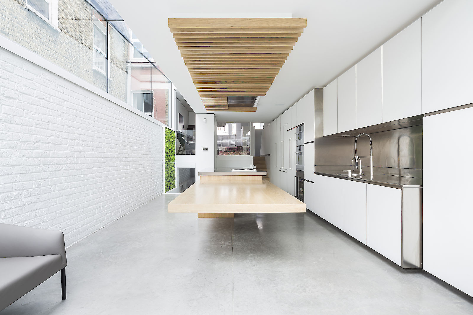 GC House in Fulham by inaki leite design. Kitchen extension with glass to glass skylight and cantilever dining designed by iñaki leite