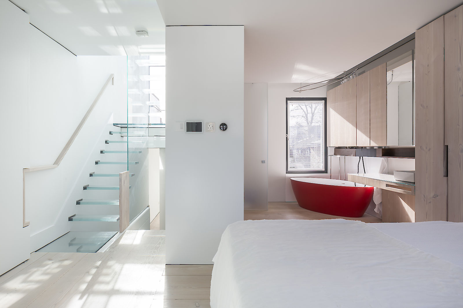 GC House by inaki leite design. Natural light of Fulham house master bedroom entrance with en-suite and Dinesen cupboards designed by iñaki leite