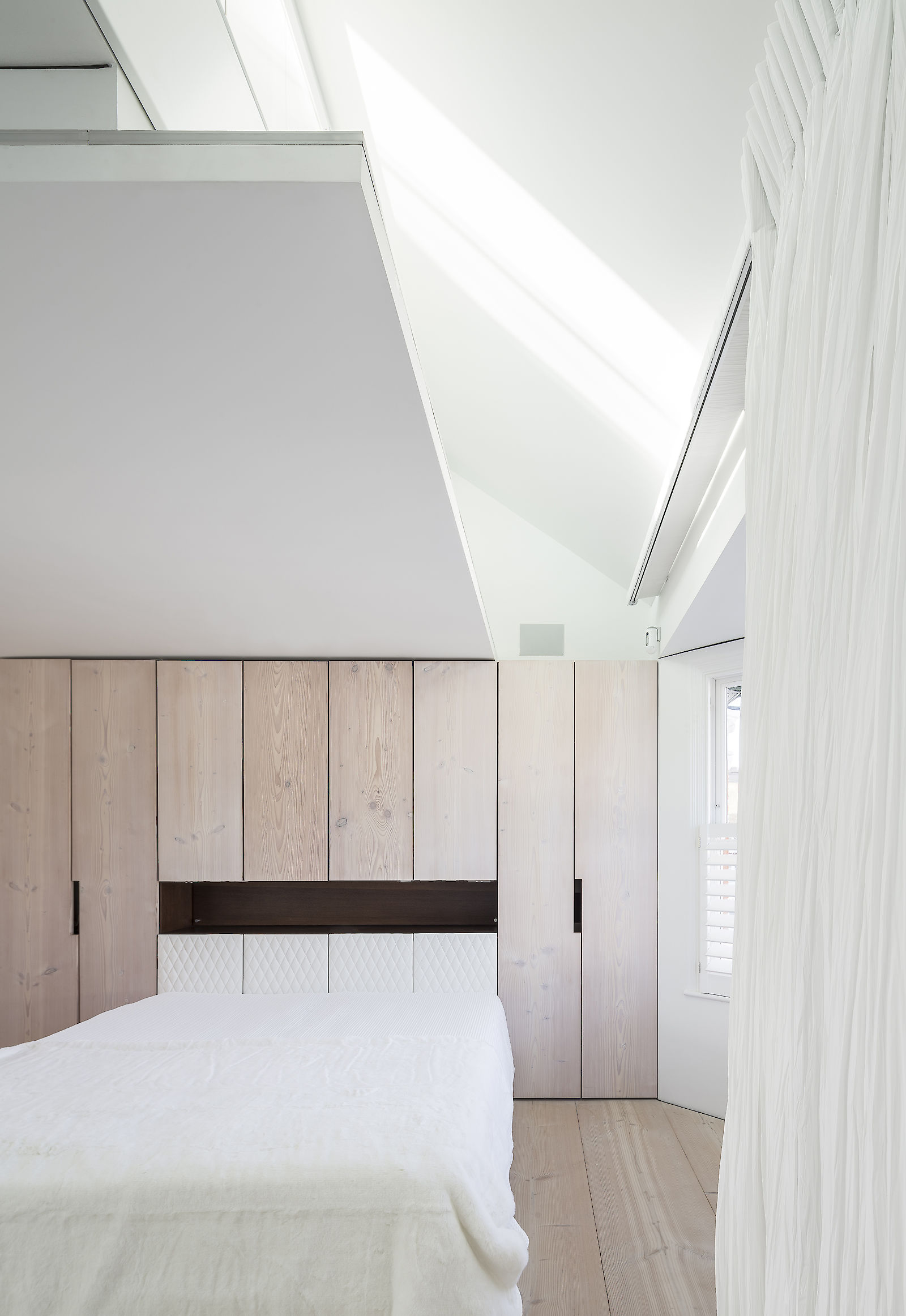GC House by inaki leite design. Fulham house master bedroom with natural light from loft